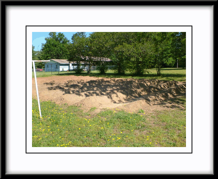 Mounding up soil for raised row concept garden.