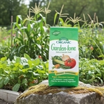 Espoma Garden-tone 3-4-4 all-natural plant food package with a vibrant vegetable garden in the background, showcasing healthy, thriving plants.
