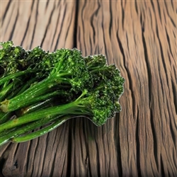Aspabroc Baby Broccoli plants with tender asparagus-like stems and small, fresh green leaves growing in a garden bed.